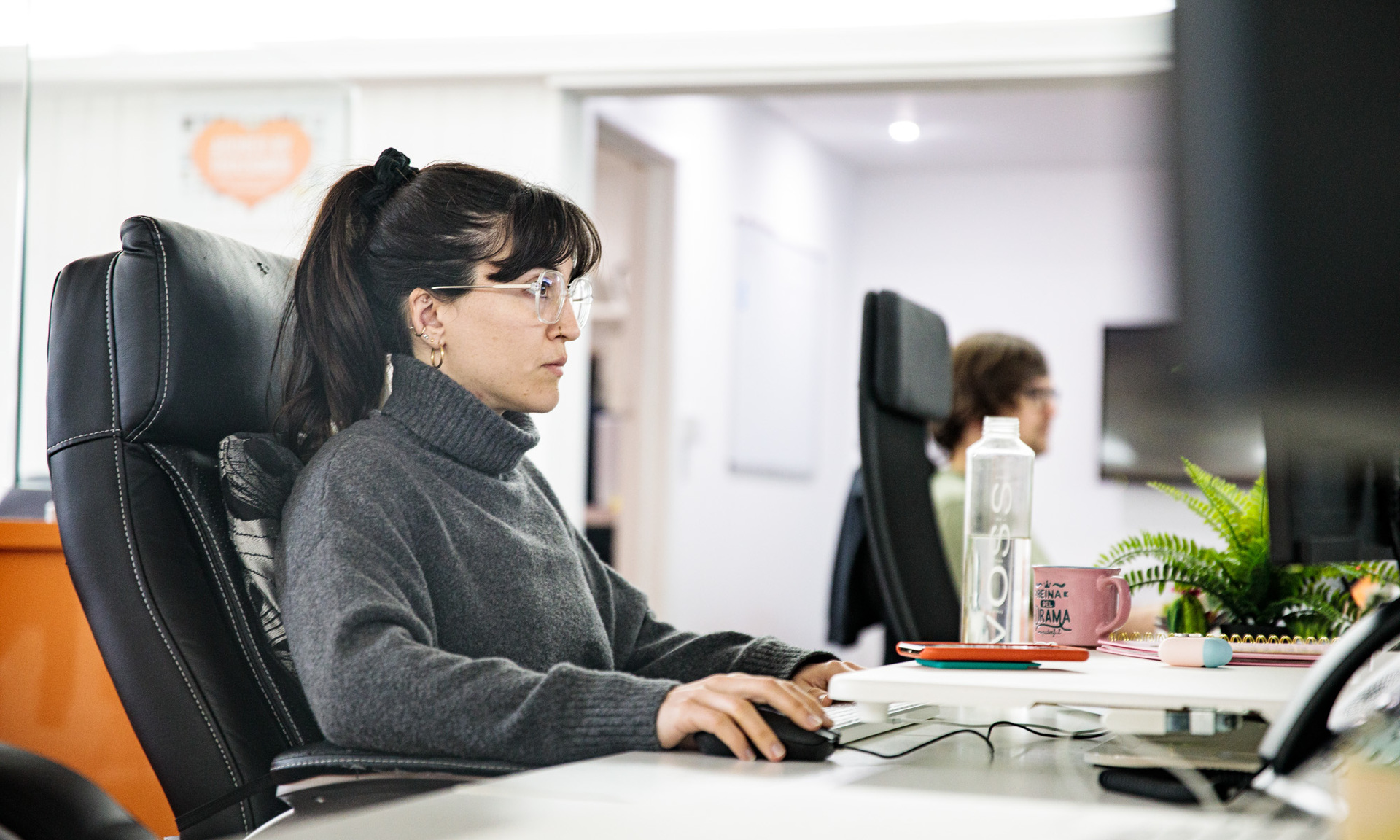 A woman sat at a desk, designing a responsive website
