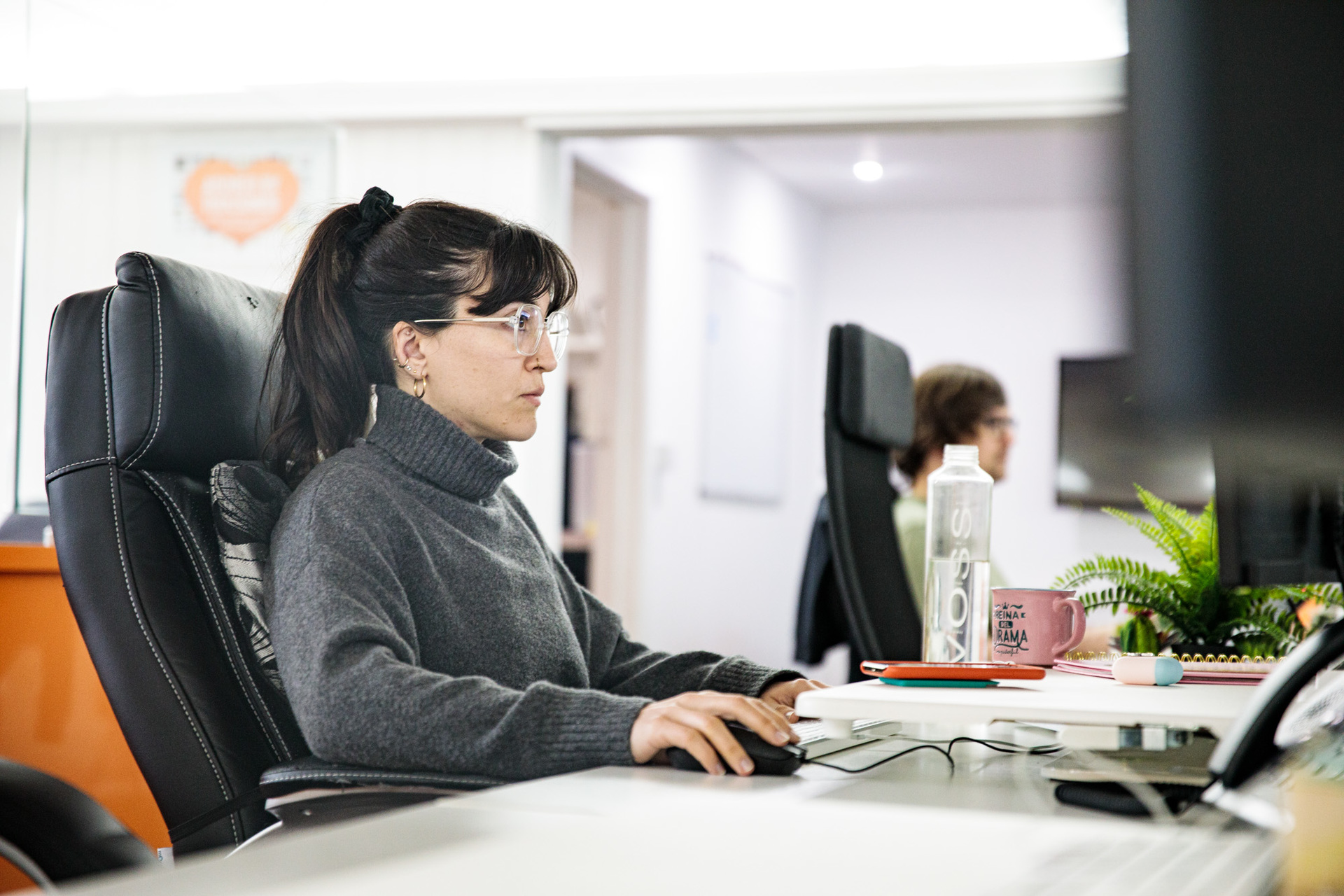 A woman sat at a desk, designing a responsive website